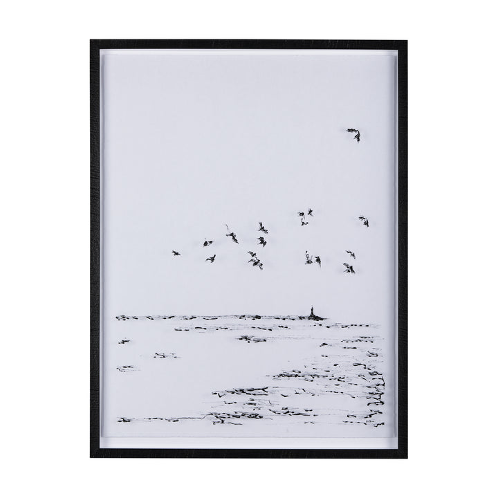 Framed black and white artwork of birds flying over water.