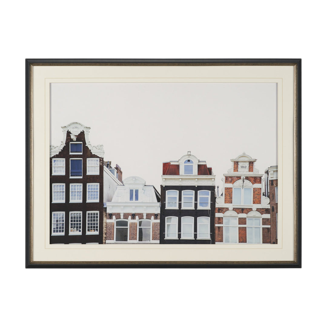 Framed artwork of three stylized buildings on a white background