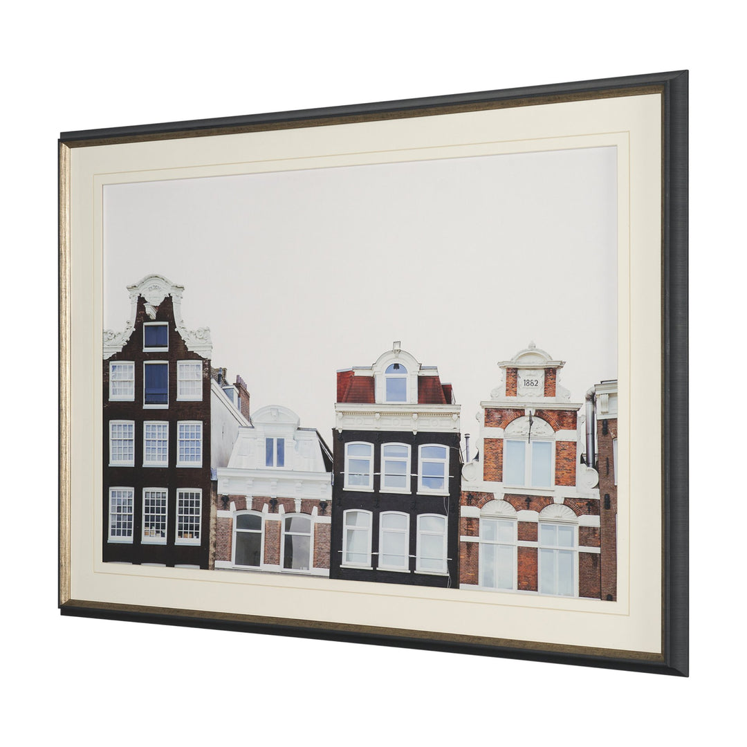 Framed artwork of a architectural scene with buildings.