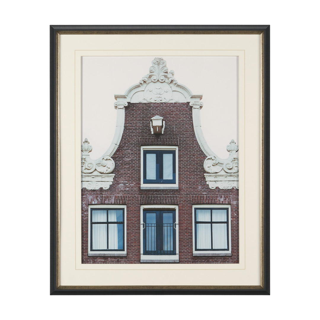 Framed artwork of a brick building with decorative elements on a white background