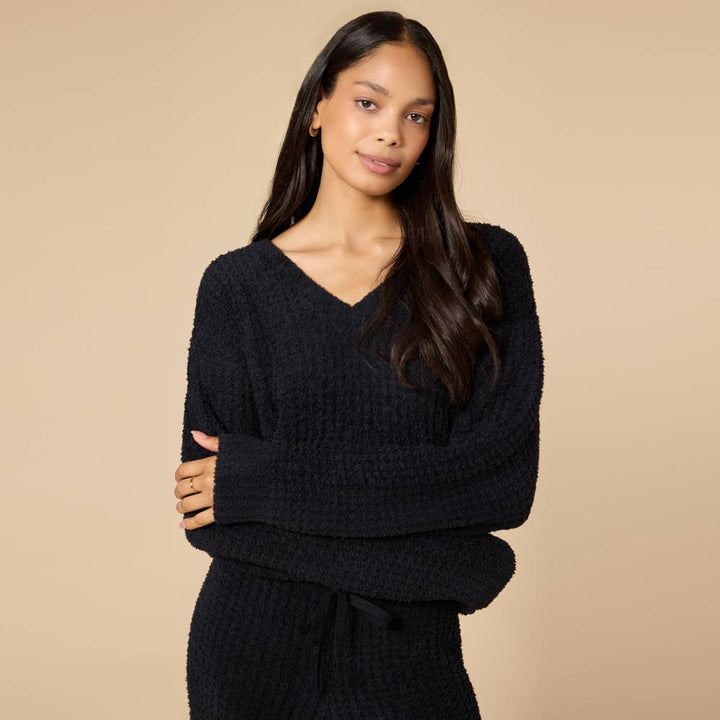 woman wearing black marshmellow waffle knit pajama set