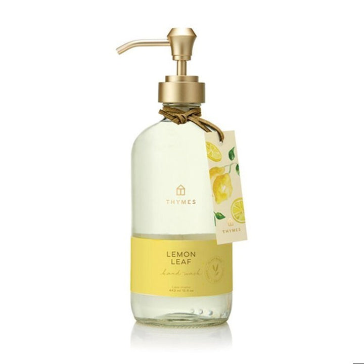 Hand soap bottle with lemon leaf design on a white background