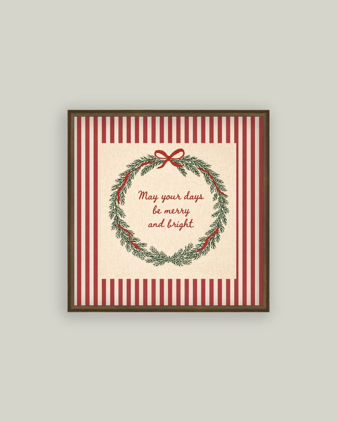 Framed Christmas-themed print with wreath and text on a striped background
