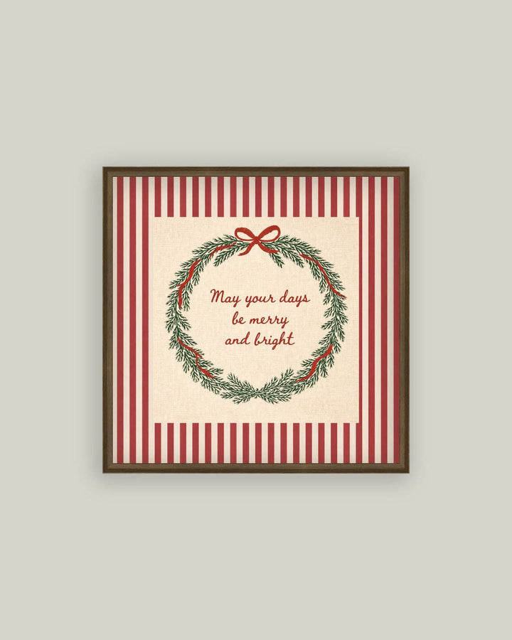 Framed Christmas-themed print with wreath and text on a striped background