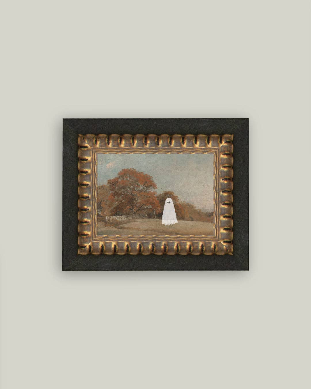 Framed artwork of a ghostly figure in a park setting on a plain wall.