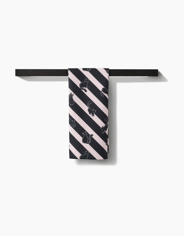 hanging towel with black cat pattern on diagonal striped background