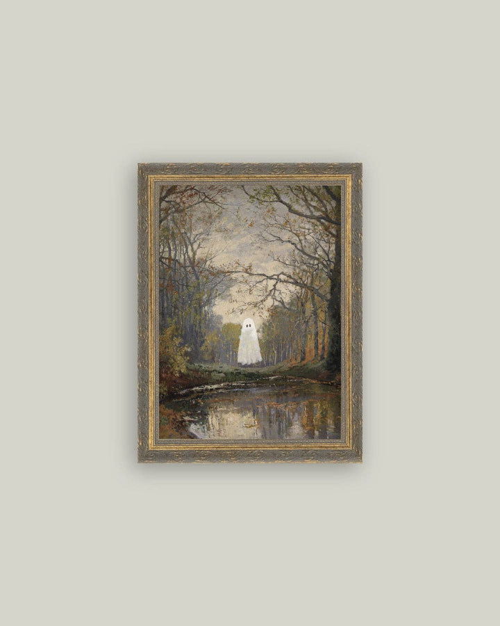 Framed artwork of a ghostly figure in a forest with a lake on a light gray wall.