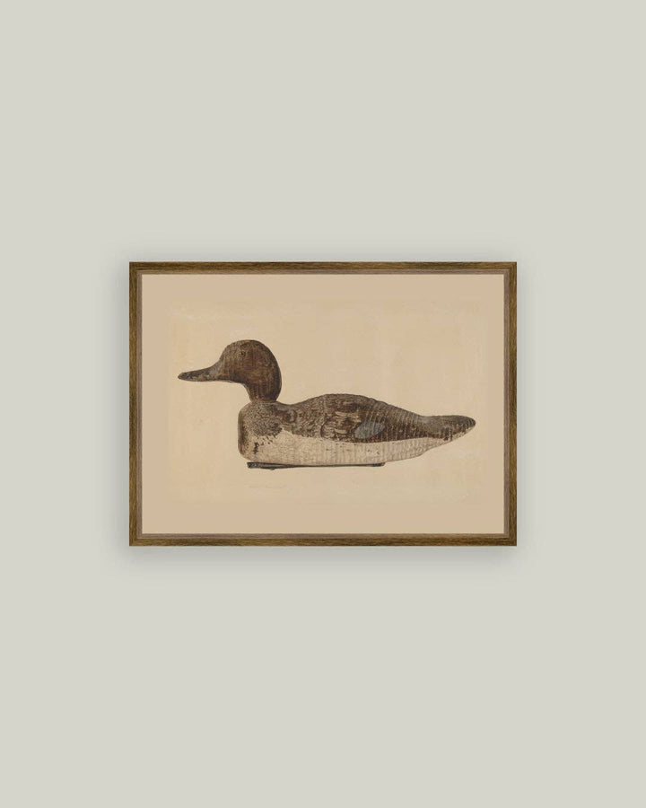 Framed artwork of a duck decoy with a beige background