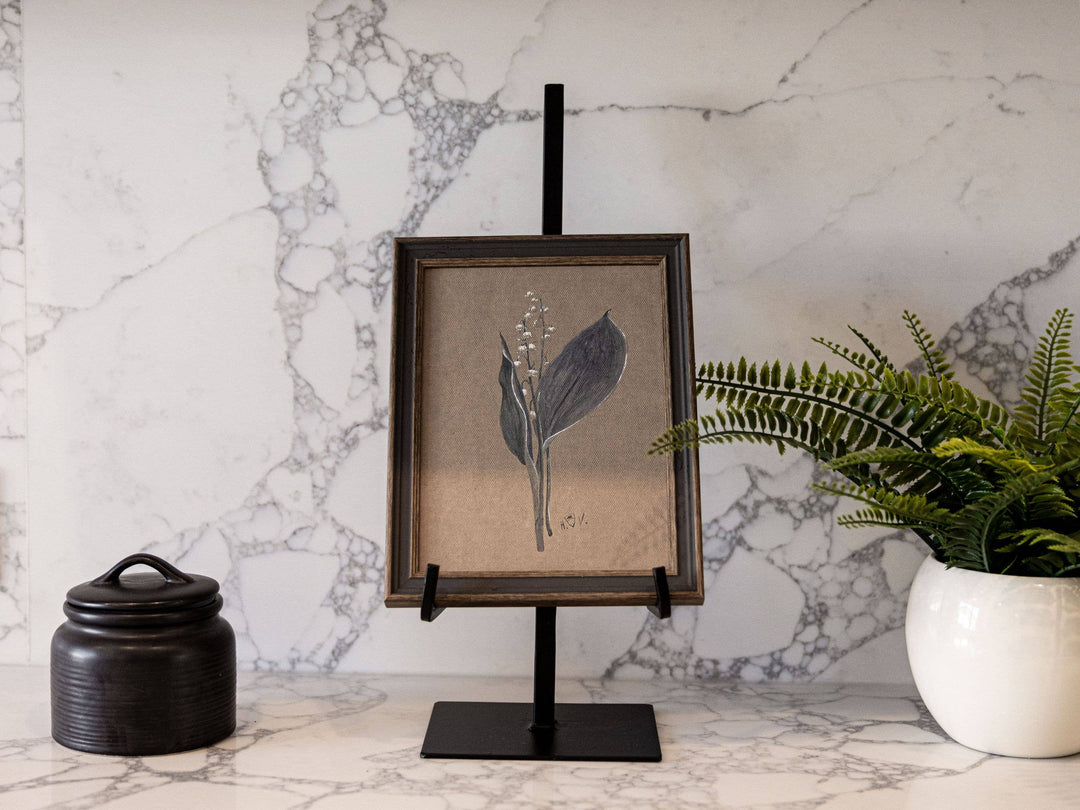 black metal easel with rectangular base