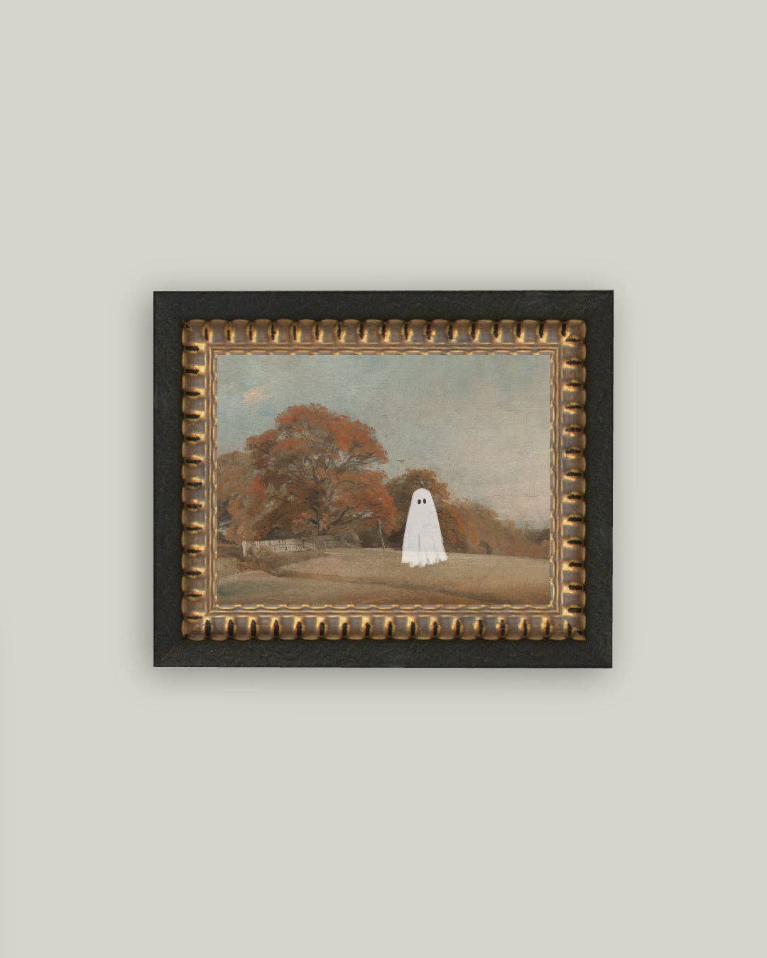 Framed artwork of a ghostly figure in a park setting on a plain wall.