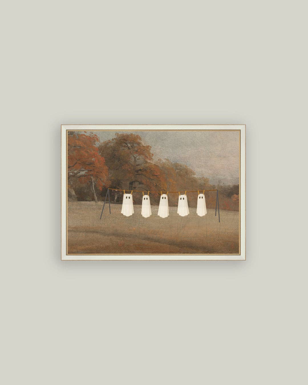 Framed artwork of four white ghosts on a wire against an autumn landscape.