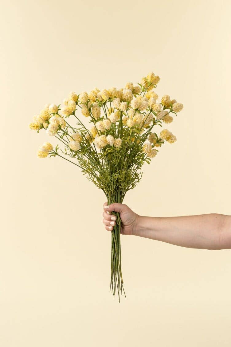 bouquet of yellow flowers against a beige background