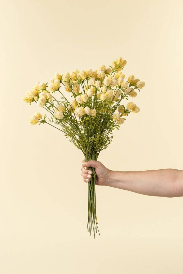 bouquet of yellow flowers against a beige background