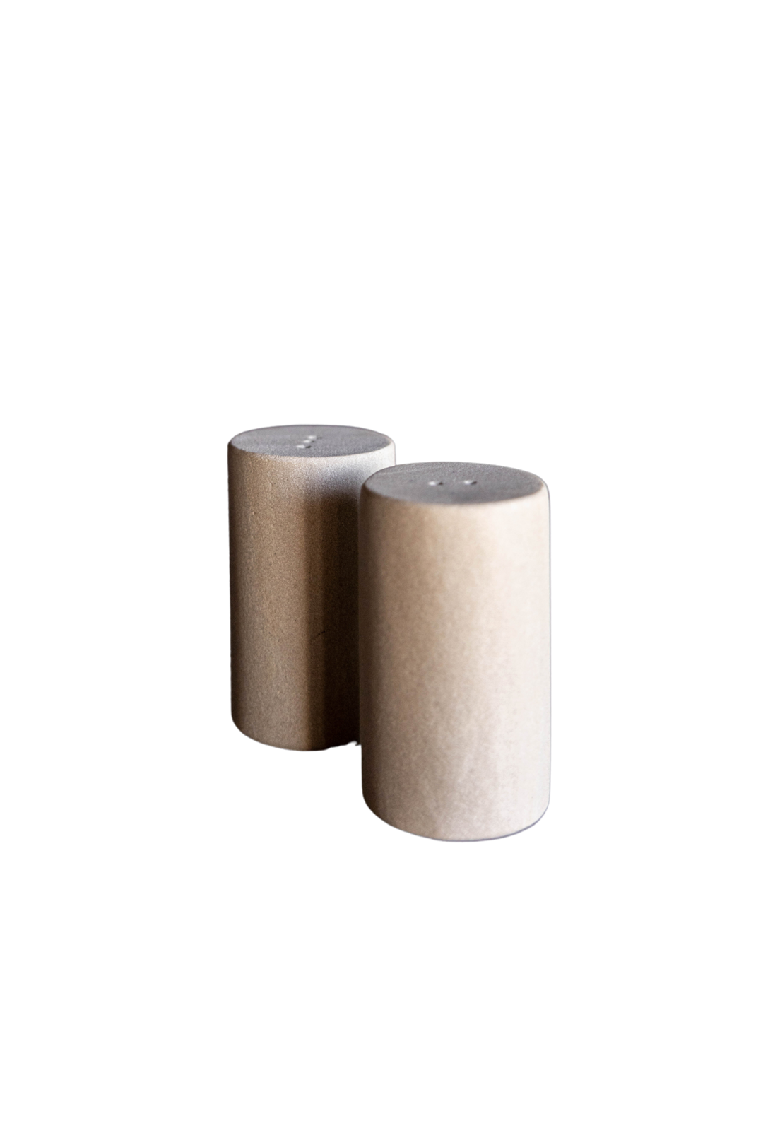 Two cylindrical beige salt and pepper shakers with dimensions indicated on a white background