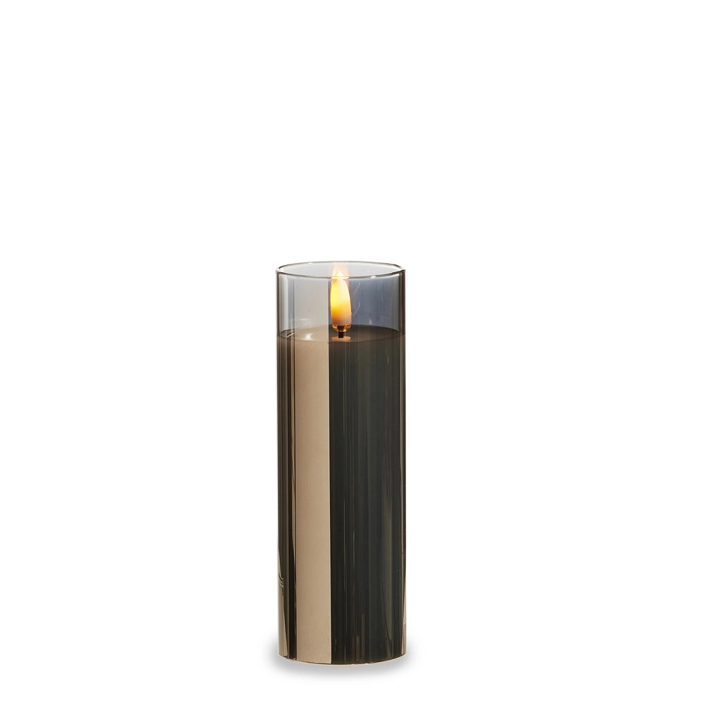 Cylindrical candle with a metallic base on a white background