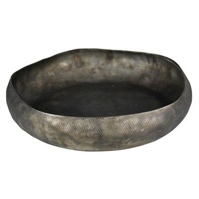 A round metal tray with a hand hammered texture and an antiqued finish.