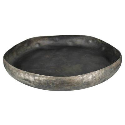 A round metal tray with a hand hammered texture and an antiqued finish.