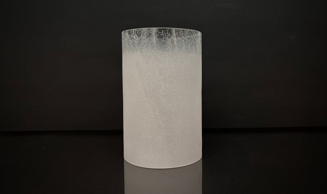 Cylindrical white textured vase on a black background