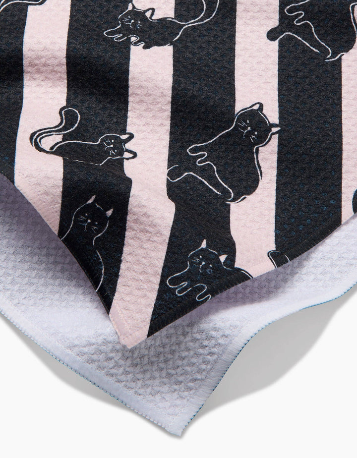 close up towel with black cat pattern on diagonal striped background