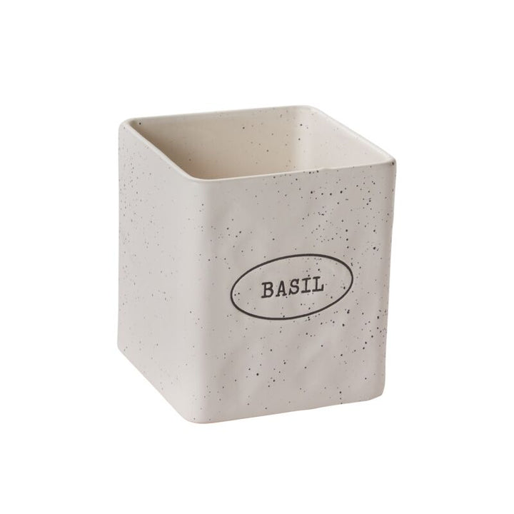 Speckled ceramic container with 'Basil' label on a white background