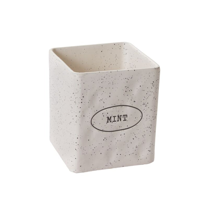 Speckled ceramic container with 'Mint' text on a white background