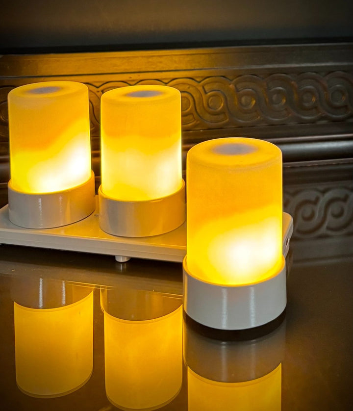 Three glowing cylindrical flame illusion lamps 