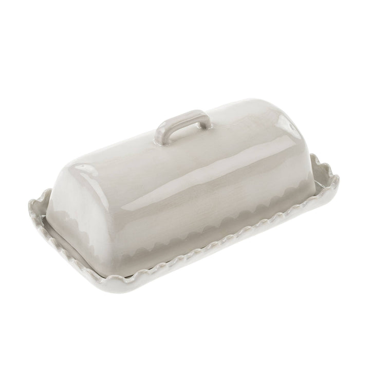 White ceramic butter dish with lid on a white background