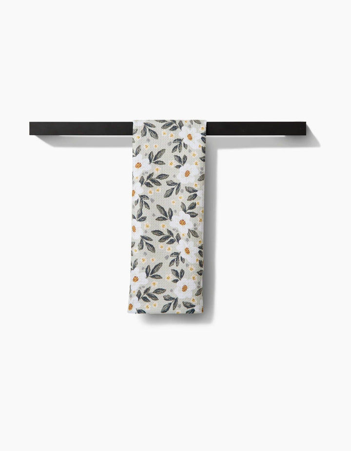 Floral patterned geometry towel with small flowers and leaves on a light background