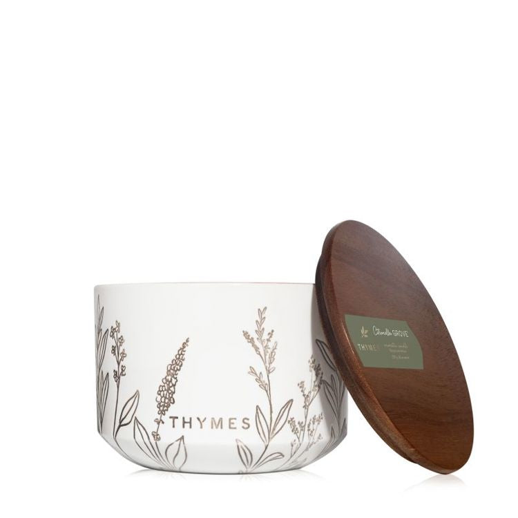 Thymes citronella candle with wooden lid on a white background