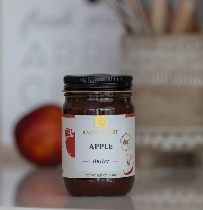 Jar of apple butter with a label on a blurred background