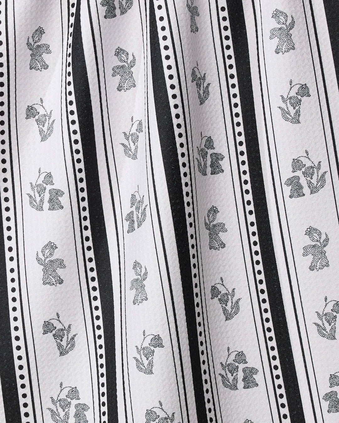 Close-up of fabric with black floral patterns on white background