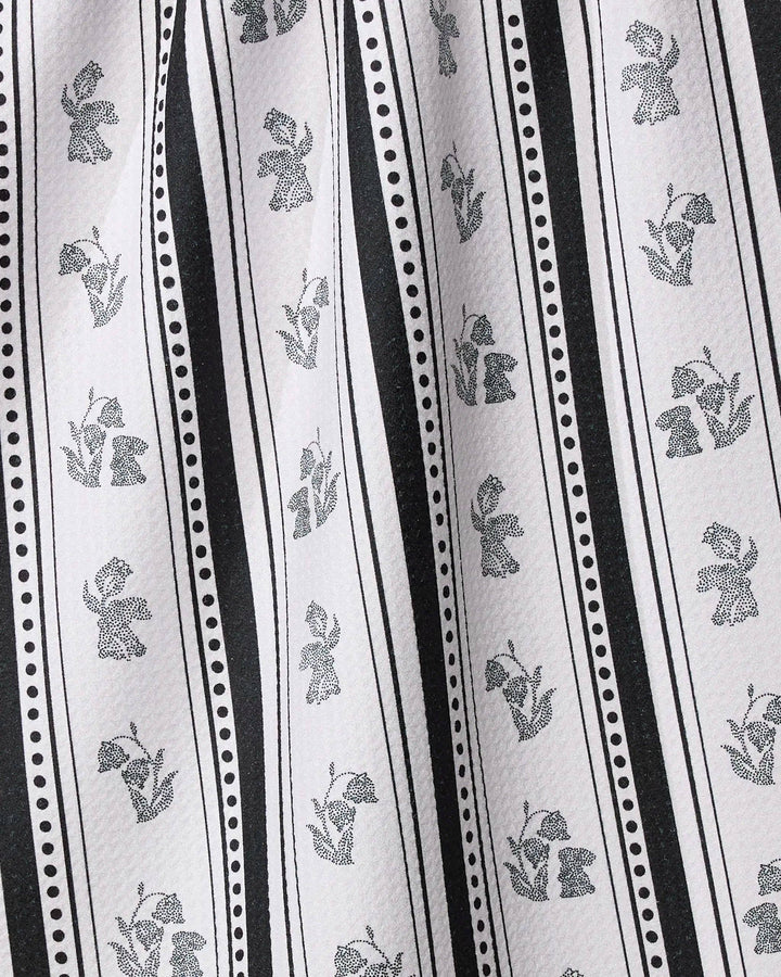Close-up of fabric with black floral patterns on white background