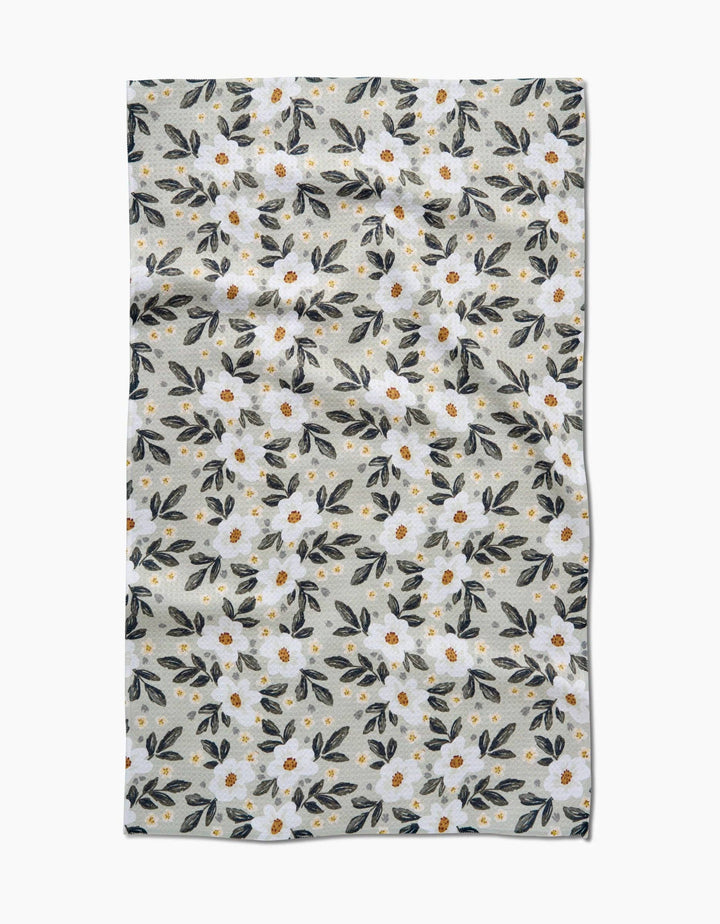Floral patterned geometry towel with small flowers and leaves on a light background