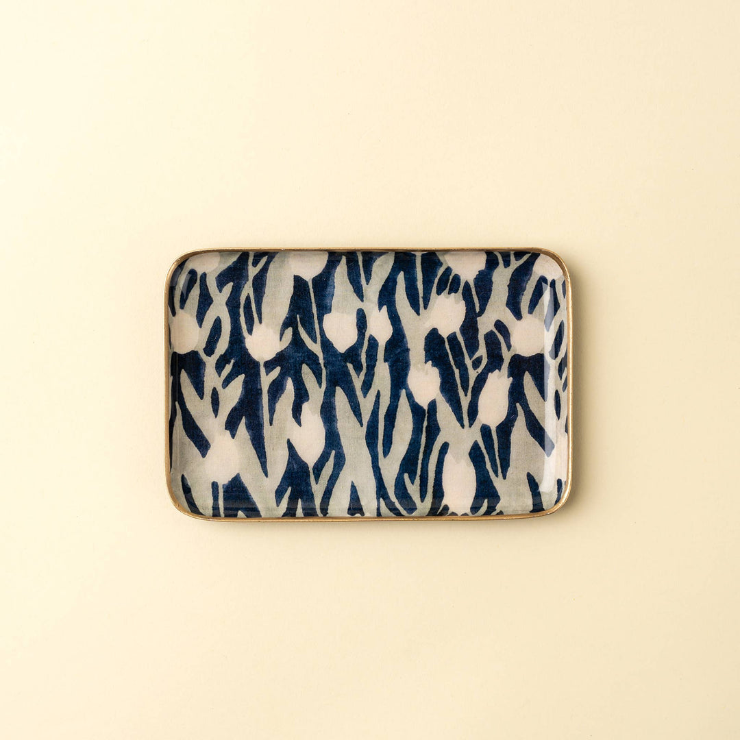 Rectangular ceramic dish with blue and white abstract pattern on a beige background