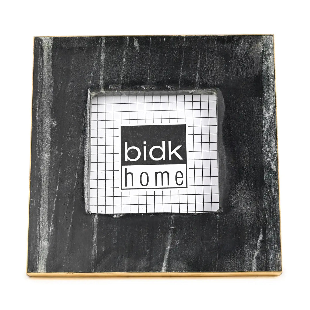 Black marble photo frame with 'bidk home' logo on a white background