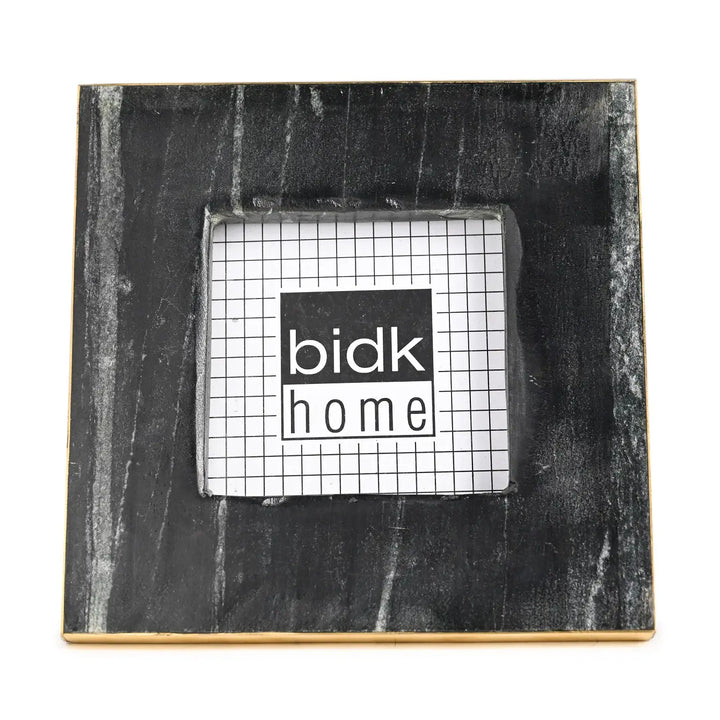 Black marble photo frame with 'bidk home' logo on a white background