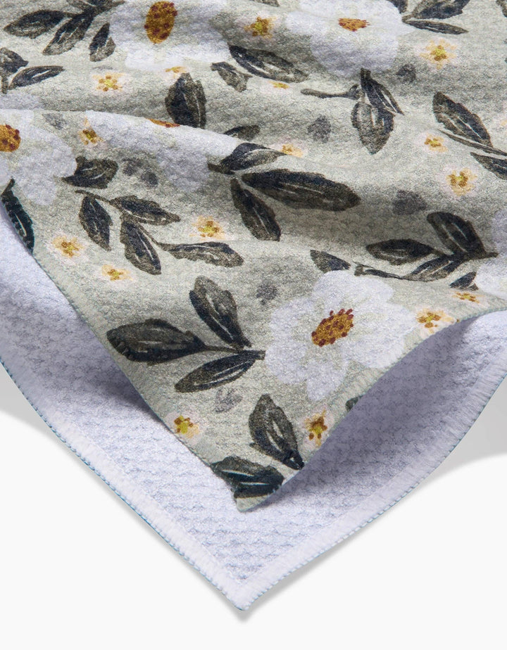 Floral patterned geometry towel with small flowers and leaves on a light background