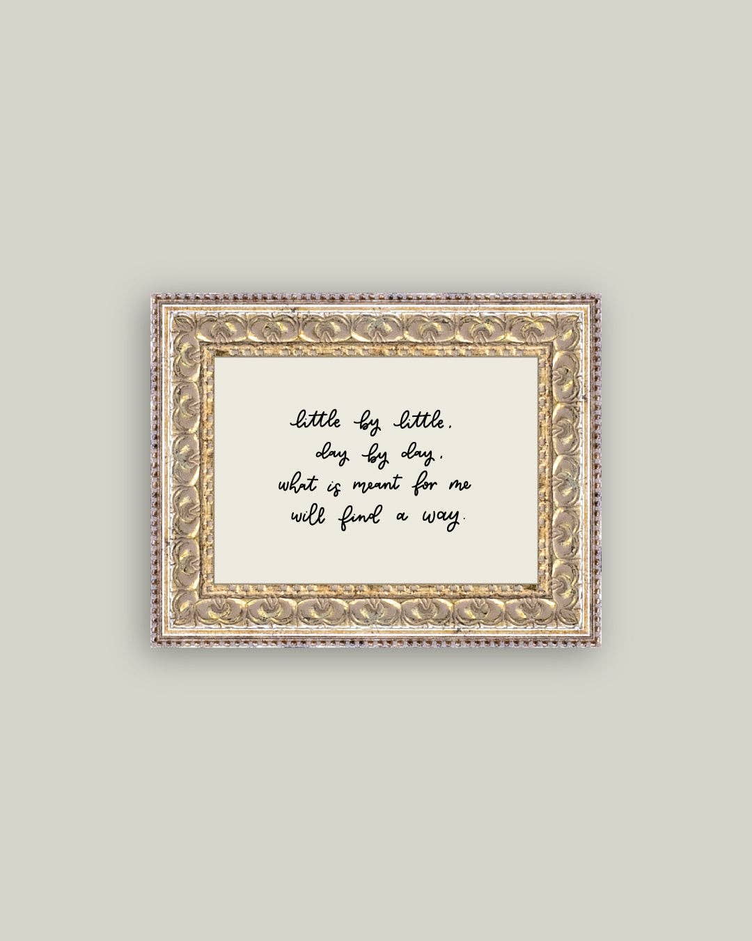 Decorative framed print with a motivational quote on a light gray background