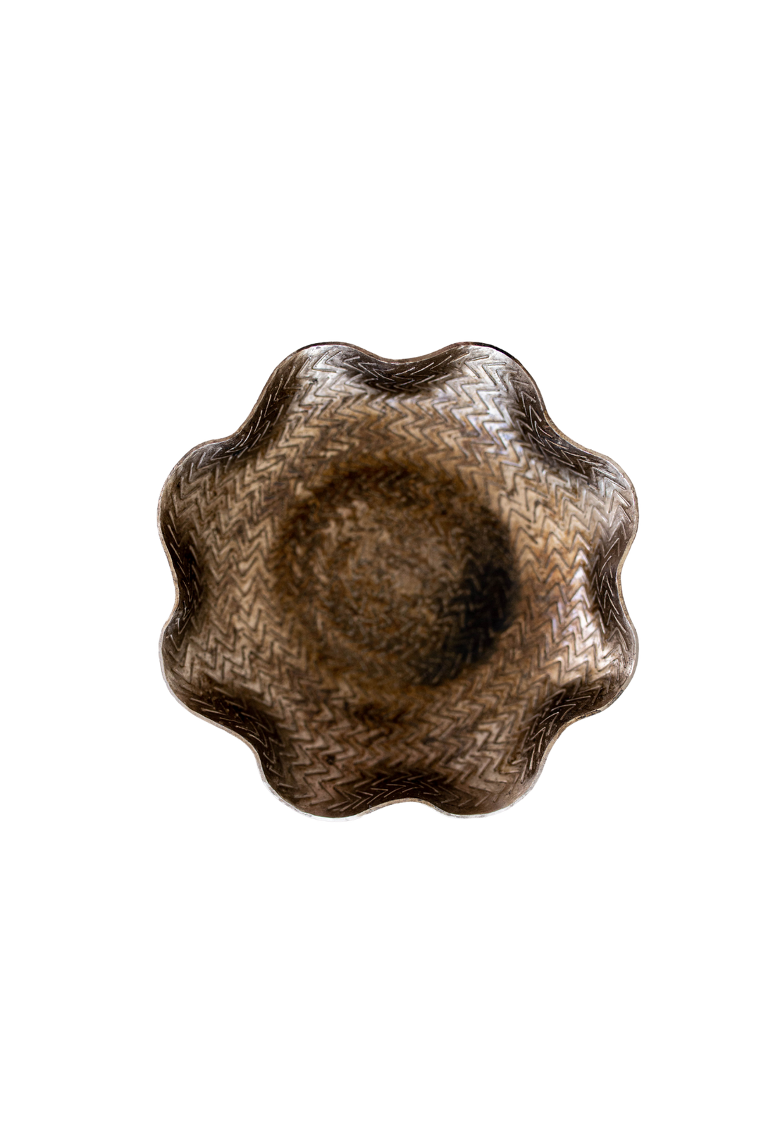 Decorative brown bowl with wavy edge on a white background