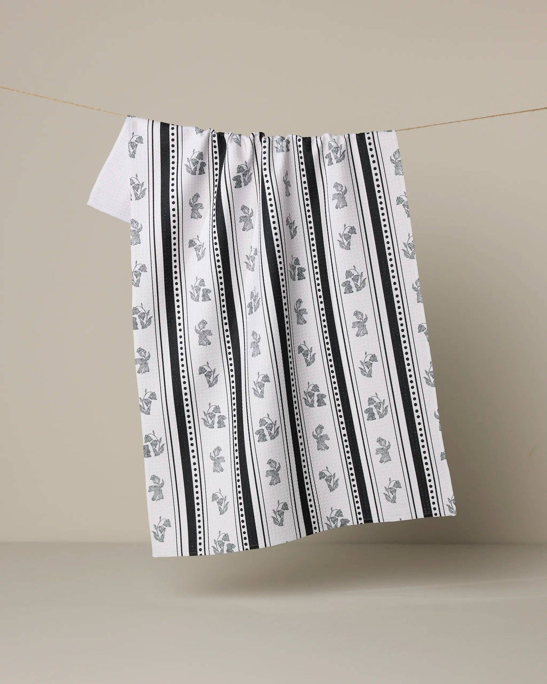 Striped towel with black and white pattern on a beige background