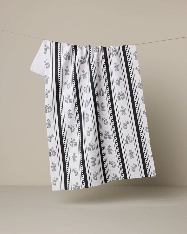 Striped towel with black and white pattern on a beige background