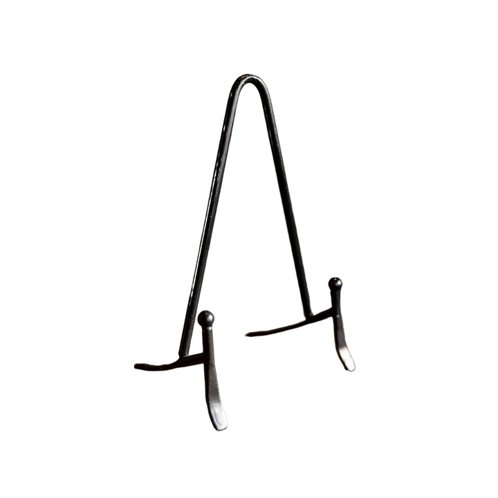 Black metal easel on a white background