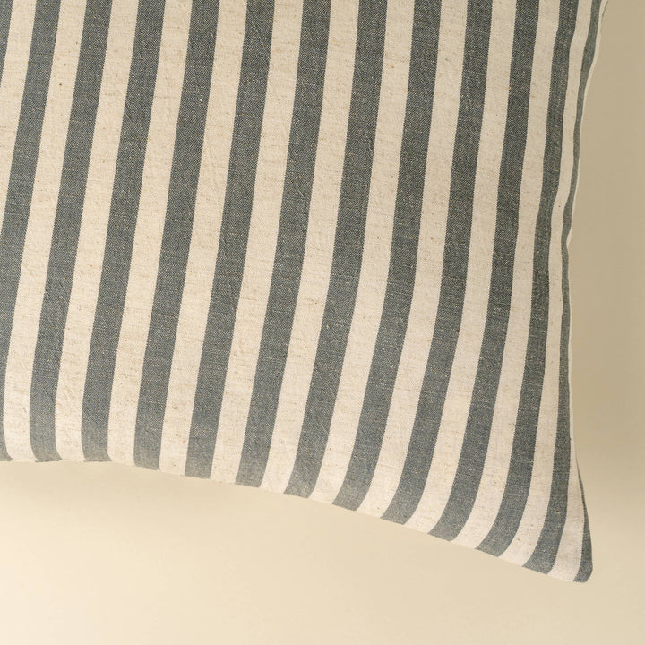 Striped fabric with blue and white vertical stripes on a beige background