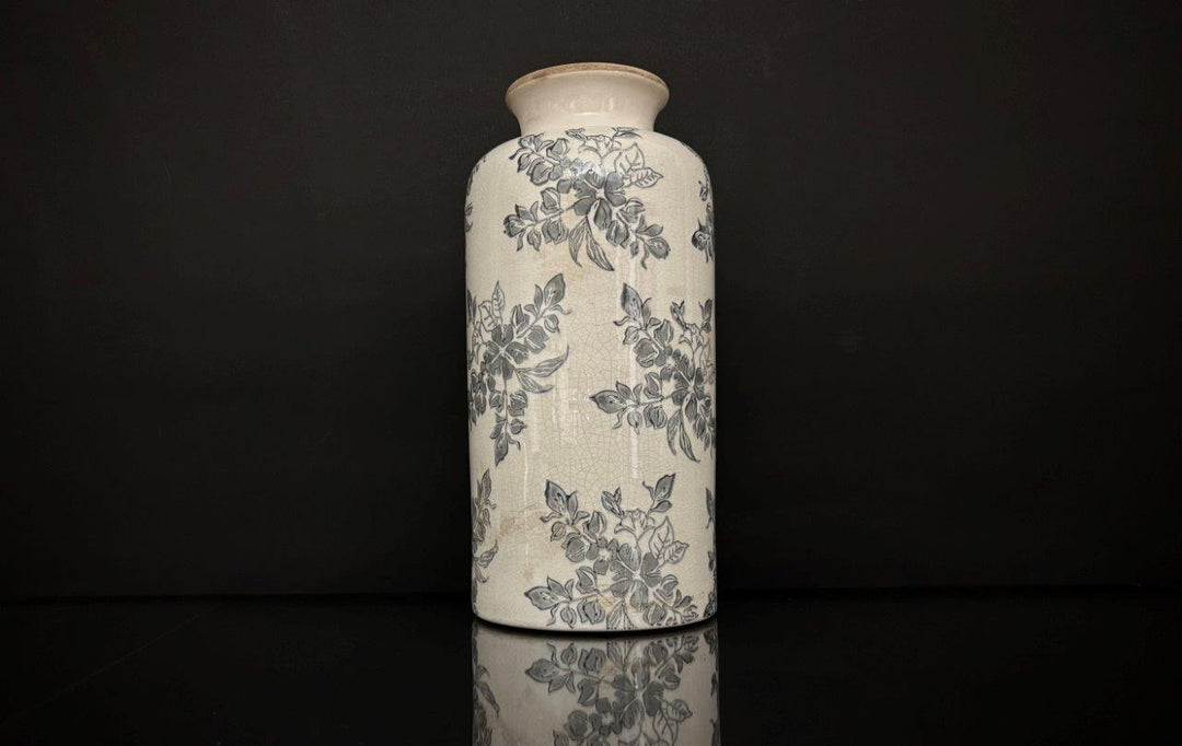 Ceramic vase with floral patterns on a black background