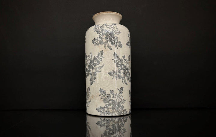Ceramic vase with floral patterns on a black background