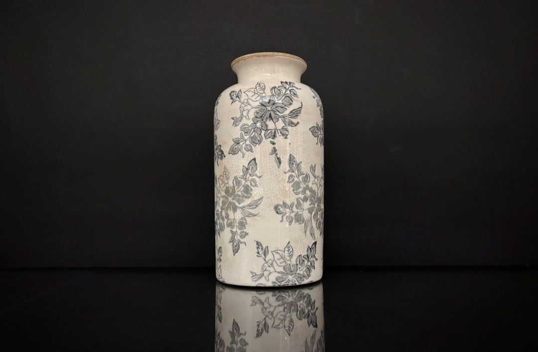 Ceramic vase with floral patterns on a black background