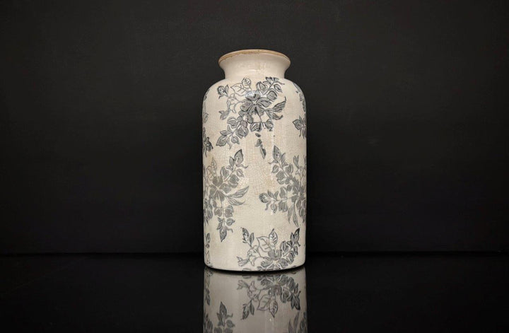 Ceramic vase with floral patterns on a black background