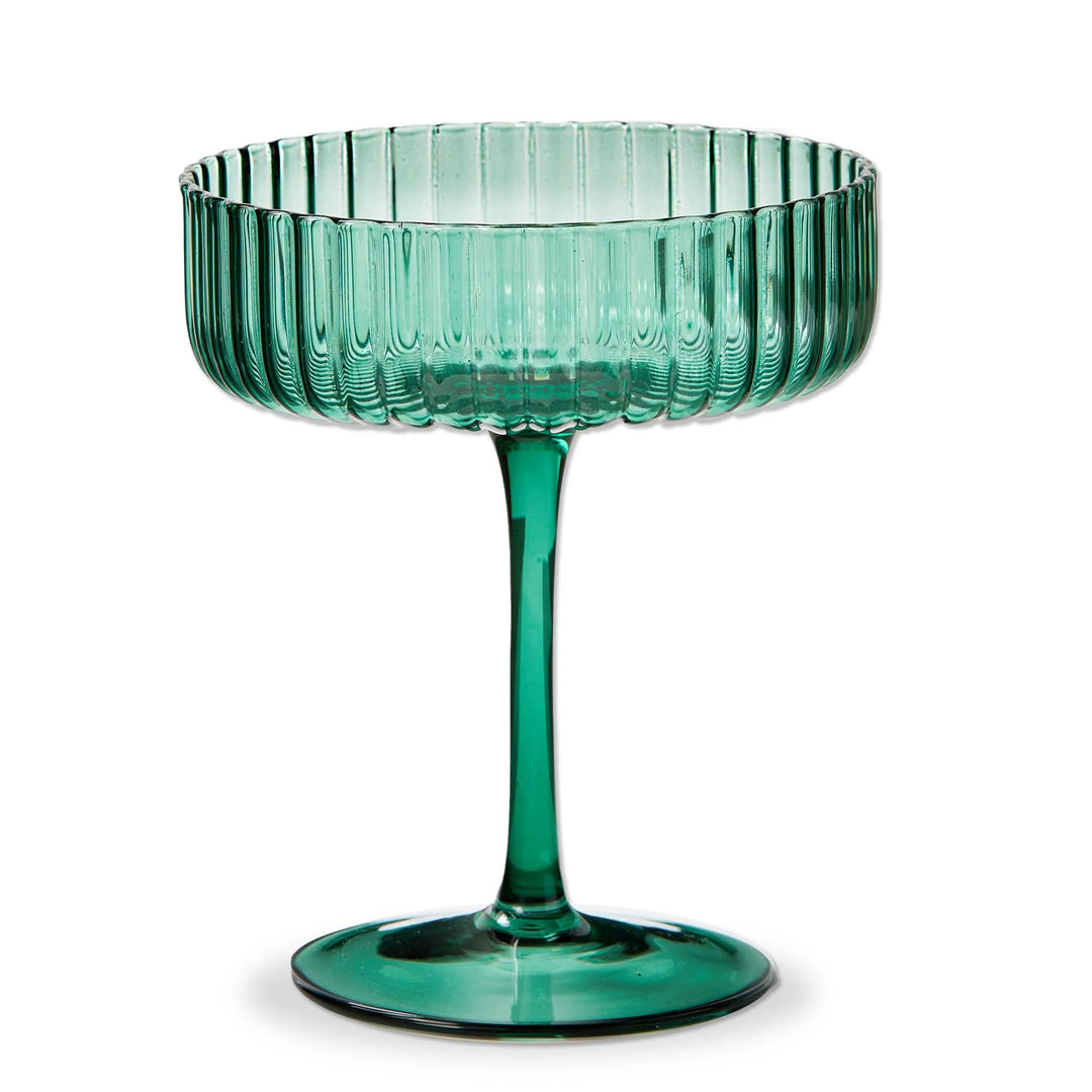 A blue green, fluted coupe glass with a stem