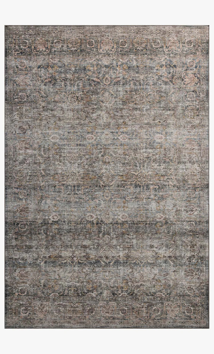 patterned rug with brown , blue, and burnt orange neutral tones