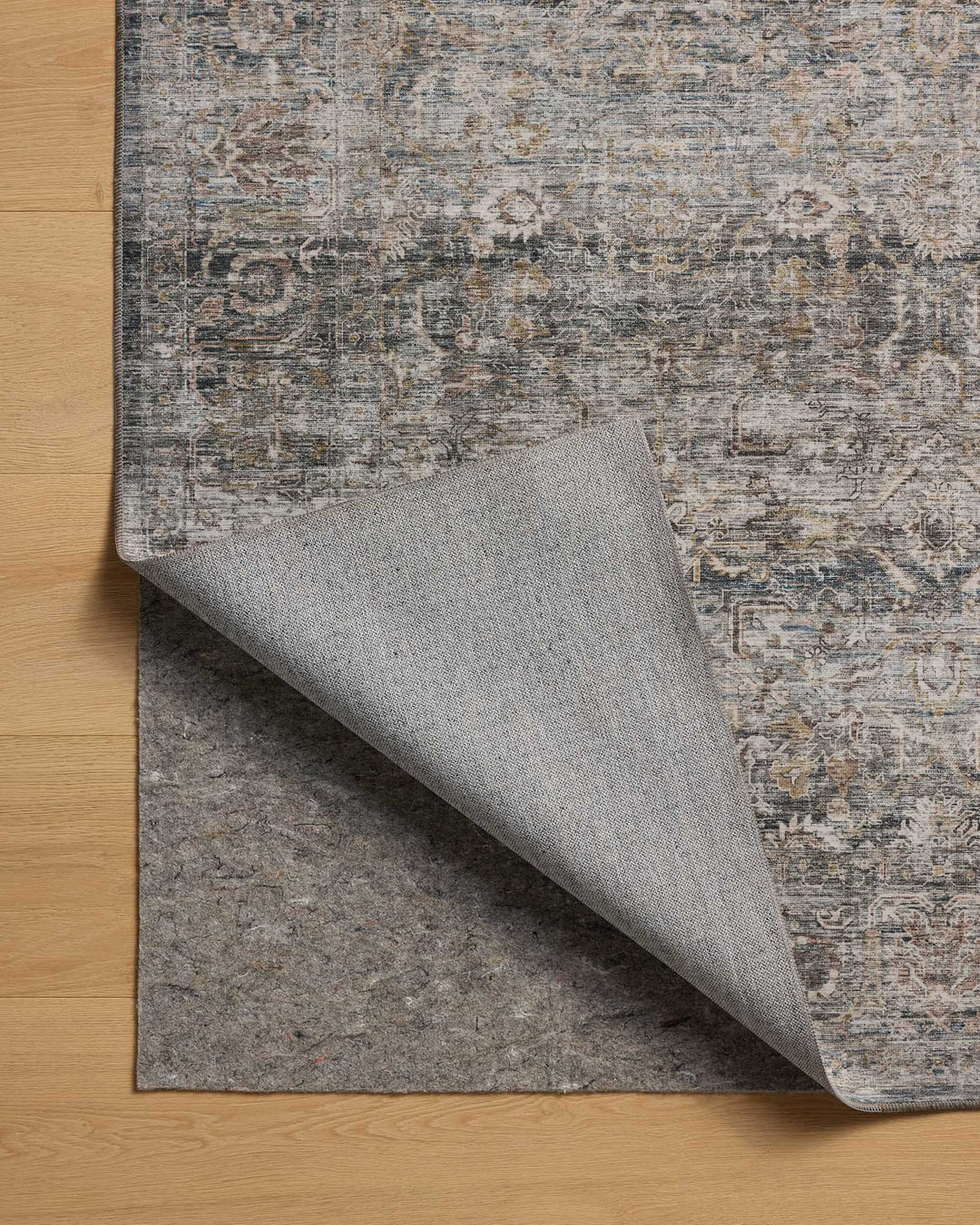 patterned rug with brown , blue, and burnt orange neutral tones